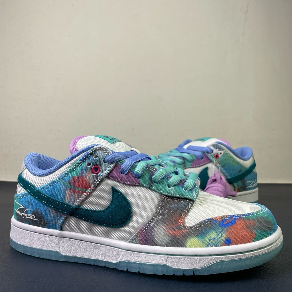 Nike SB Dunk Low Futura Laboratories - lateral side profile showing teal Swoosh and Futura signature on midsole