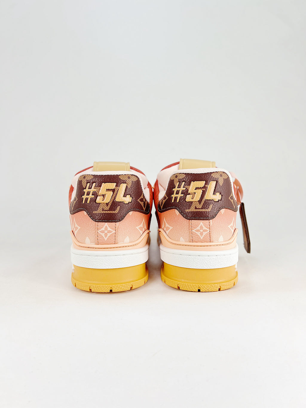 LV Trainer #54 Red Pink Yellow – rear three-quarter view