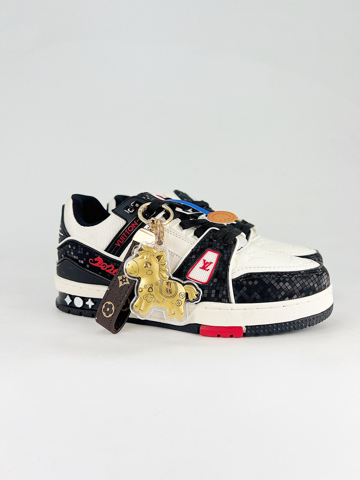 LV Trainer #54 Black White CNY – heel view showing red LV logo