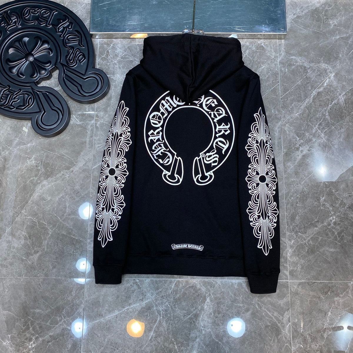 Chrome Hearts white zip-up hoodie cuff detail showing floral cross graphic and ribbed cuff construction