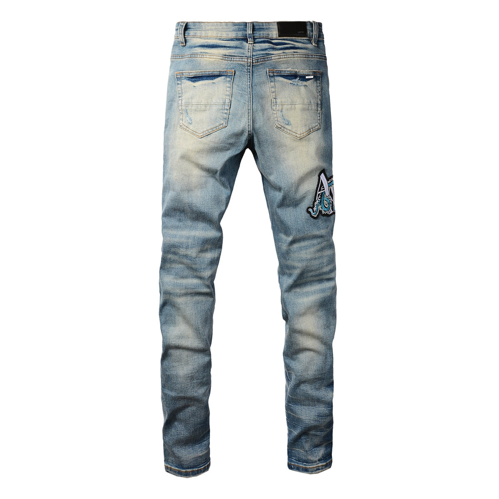 Amiri Dragon Patch Distressed Jeans – front view
