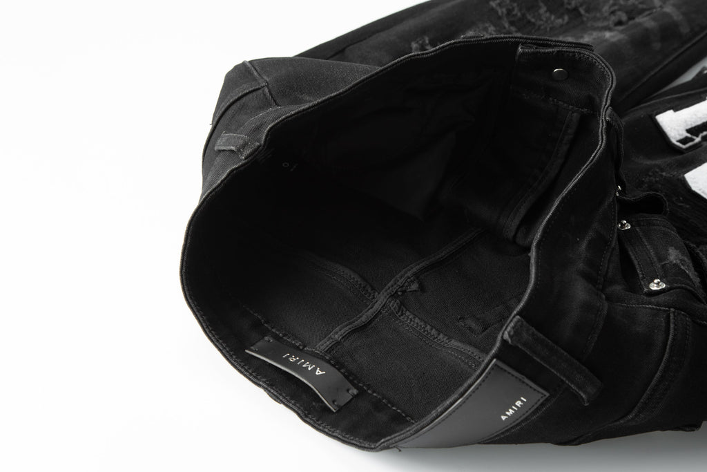 Amiri MA Varsity Letter Black Distressed Jeans - Front view