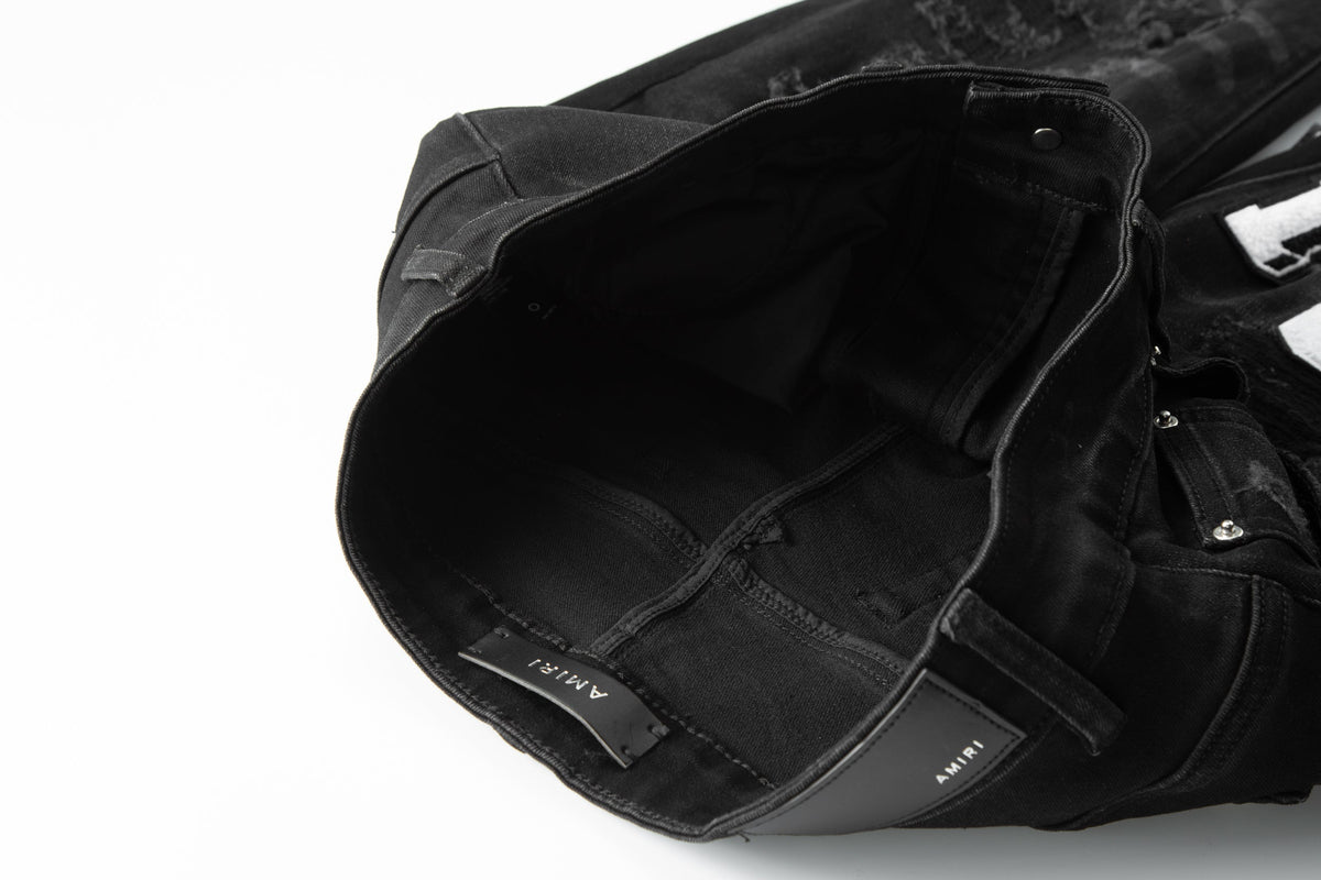 Amiri MA Varsity Letter Black Distressed Jeans - Front view