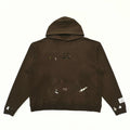 Gallery Dept. hoodie cuff detail with white paint brushstrokes and art label