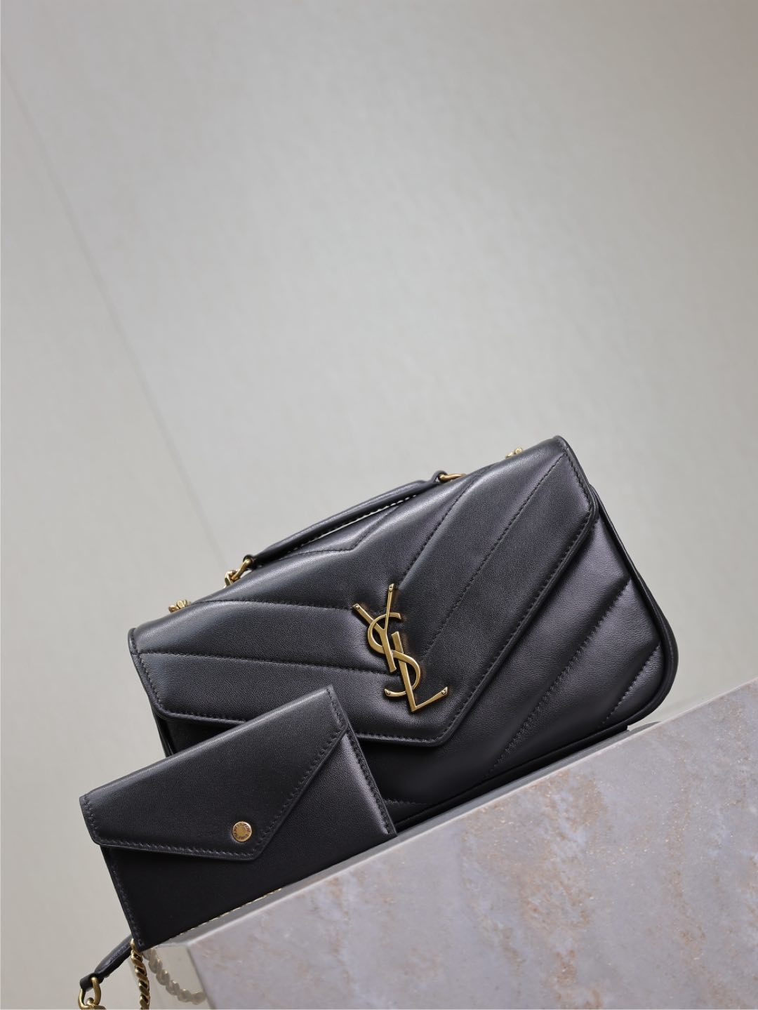 Saint Laurent Loulou bag angled view with gold hardware