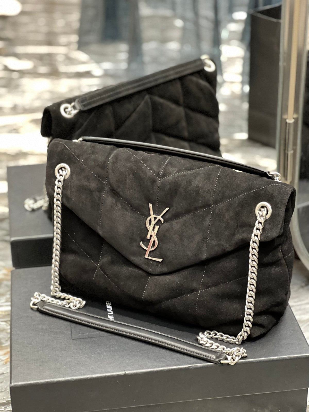 Saint Laurent Loulou Puffer bag close-up of YSL monogram hardware in suede
