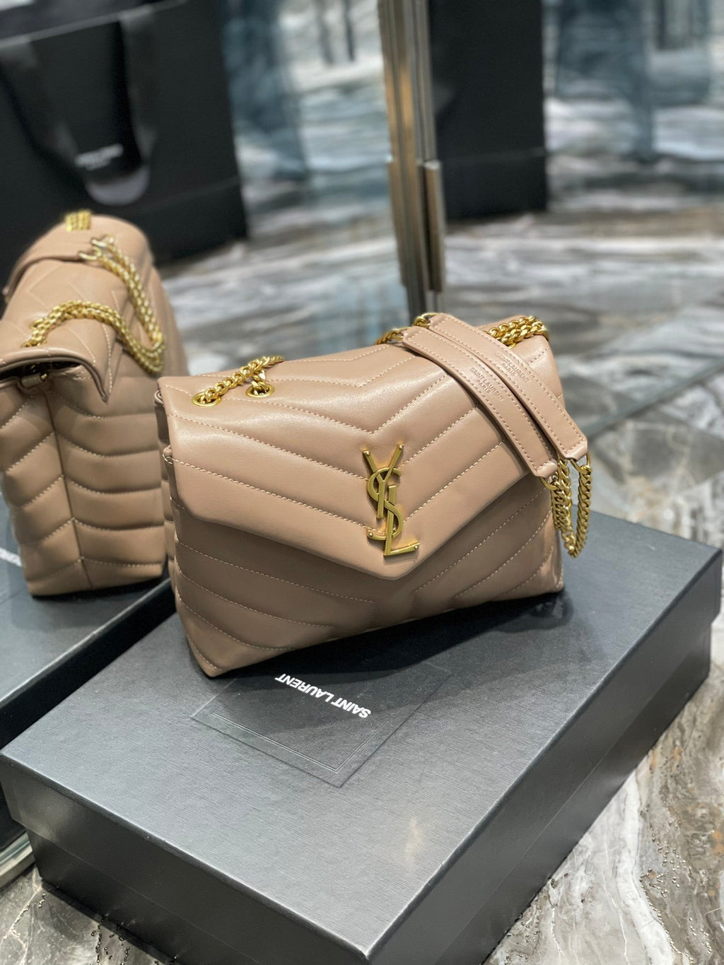 Saint Laurent LouLou small bag front view with gold YSL monogram on Saint Laurent box