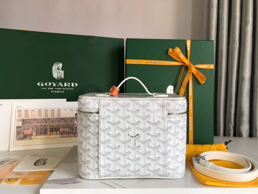 Goyard Vanity Case side view with detachable white leather crossbody strap and full Goyard packaging