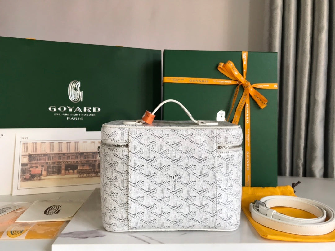 Goyard Vanity Case side view with detachable white leather crossbody strap and full Goyard packaging