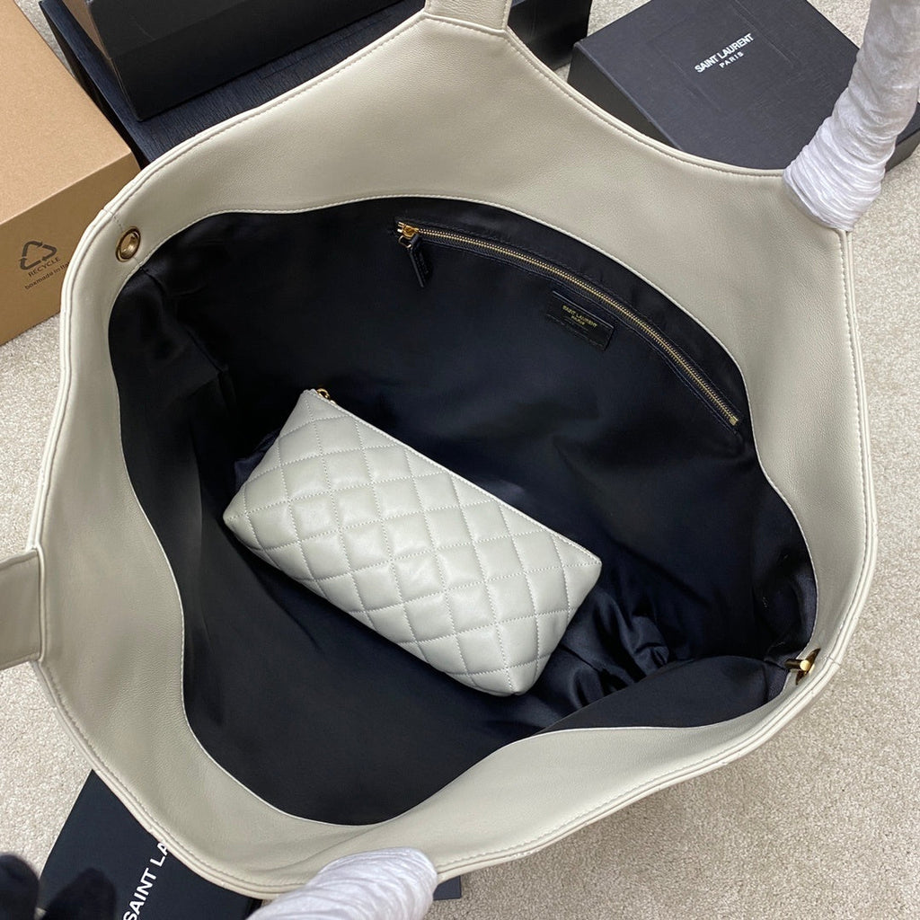 Saint Laurent Icare Maxi bag interior view with black lining, zip pocket, and quilted pouch inside