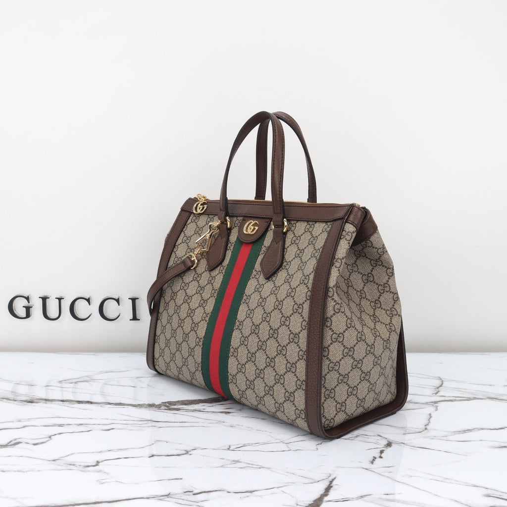 Gucci Ophidia GG medium tote side angle view with shoulder strap