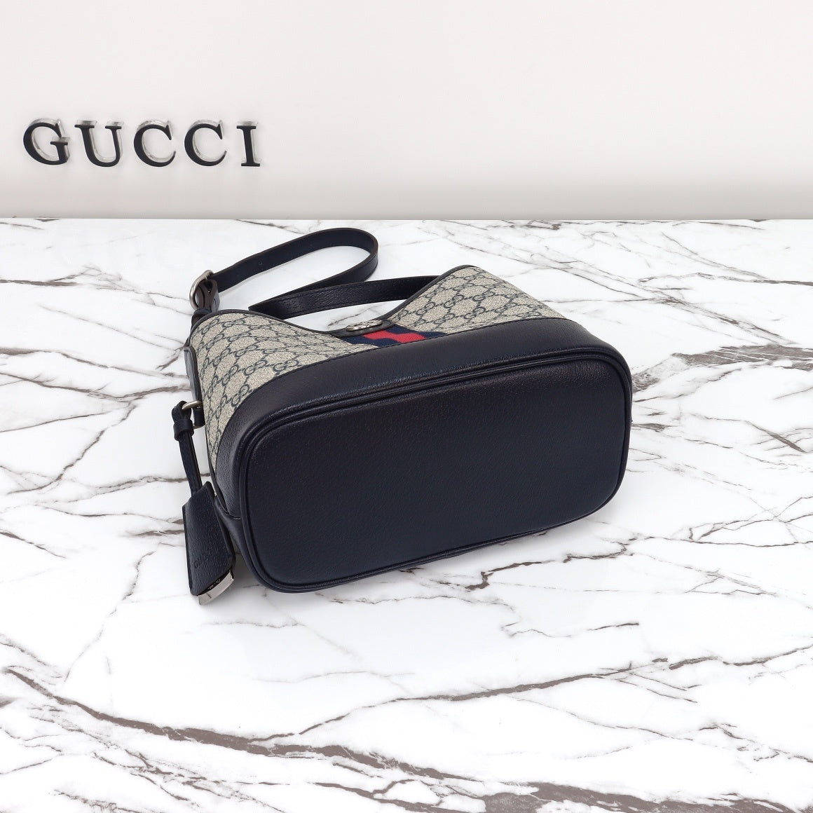 Gucci Ophidia bucket bag bottom view on marble