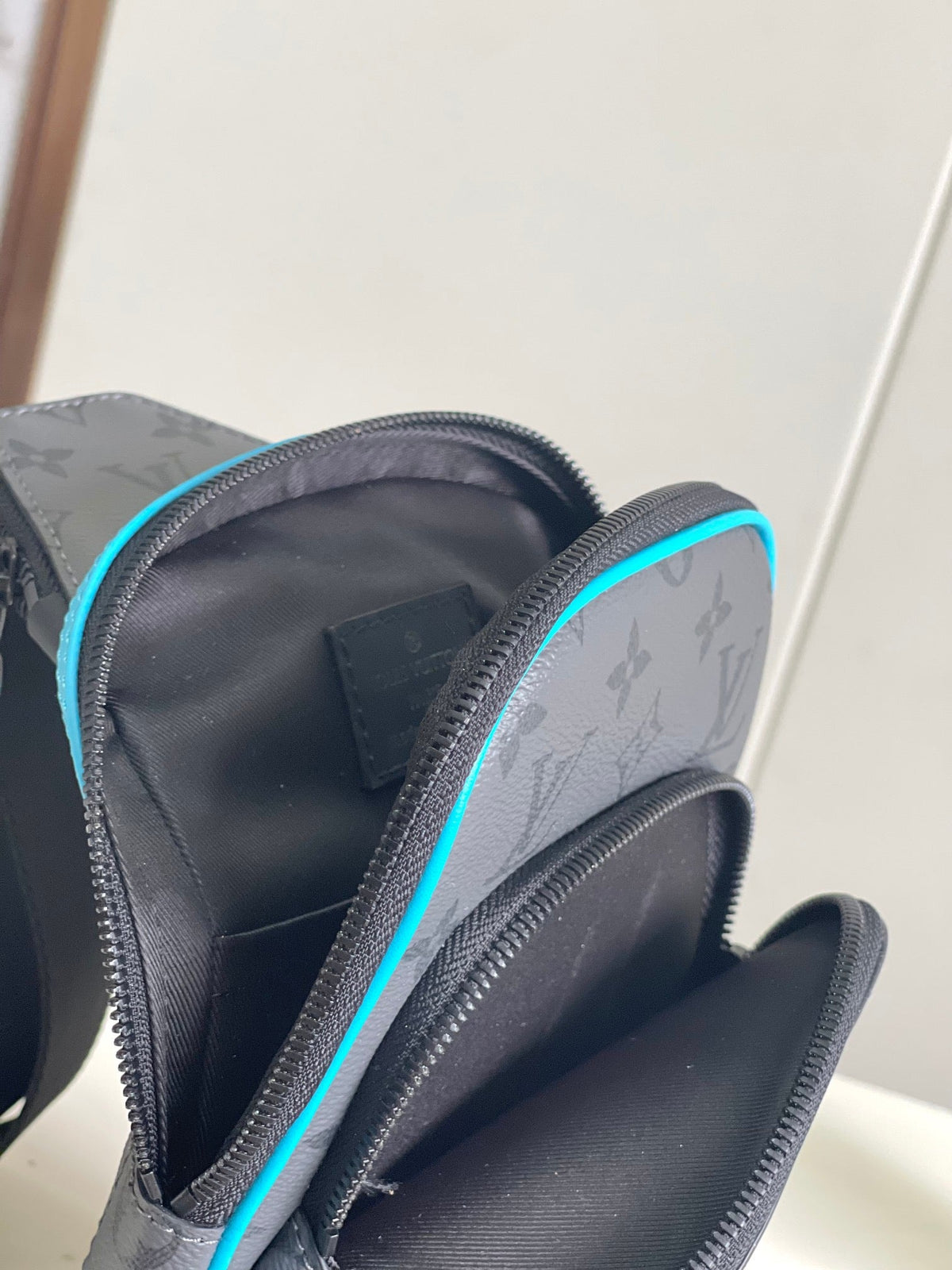 Louis Vuitton Avenue Sling Bag Monogram Eclipse Cyan – Interior Open View showing Cyan Zip Trim
