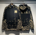 Amiri Paisley Bandana Hoodie – Black Gold front and back view on hangers side by side