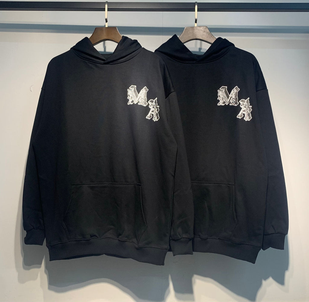 Amiri Angel Hoodie – Two Black hoodies front view showing MA monogram on chest