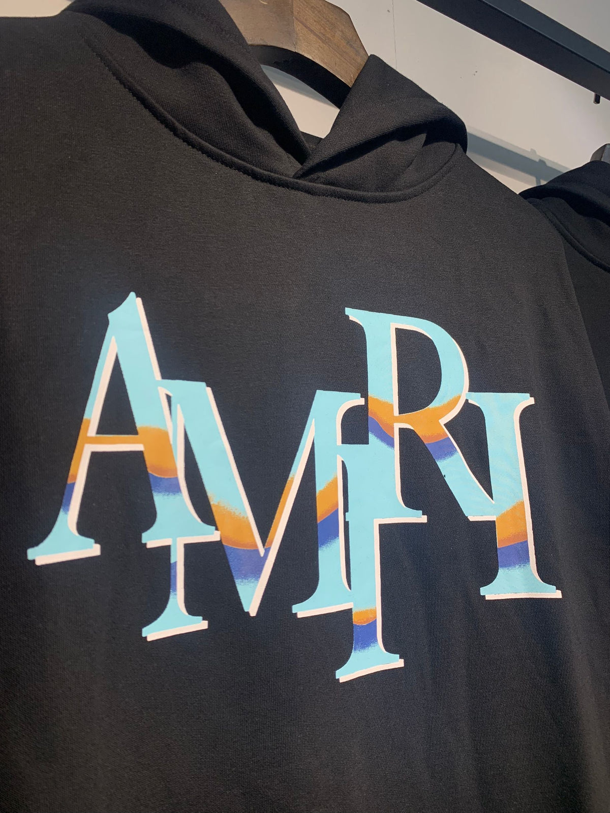 Amiri Staggered Iridescent Logo Hoodie – Close-up iridescent logo detail