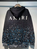 Amiri Paint Splatter Hoodie – Black back view with AMIRI lettering and splatter