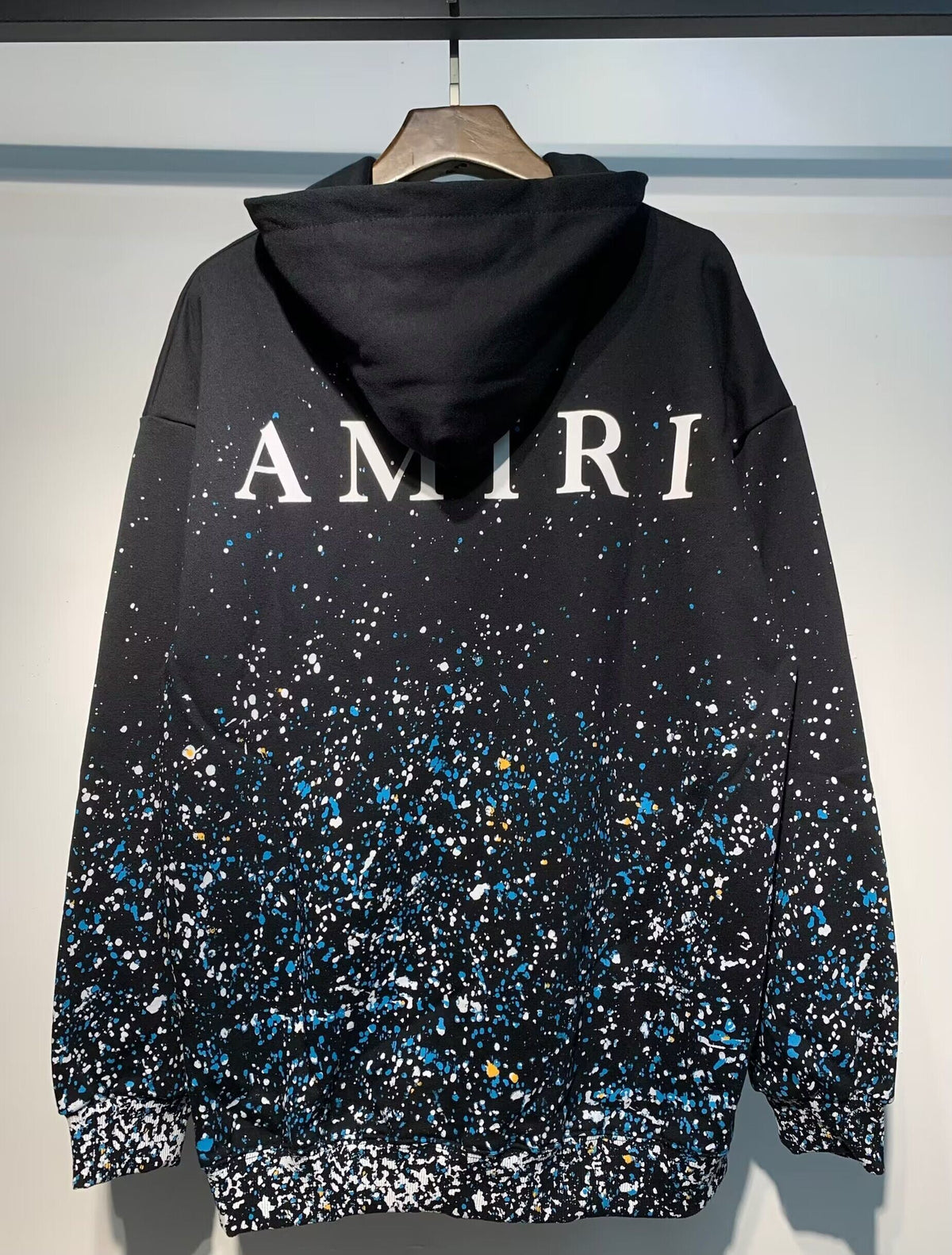 Amiri Paint Splatter Hoodie – Black back view with AMIRI lettering and splatter