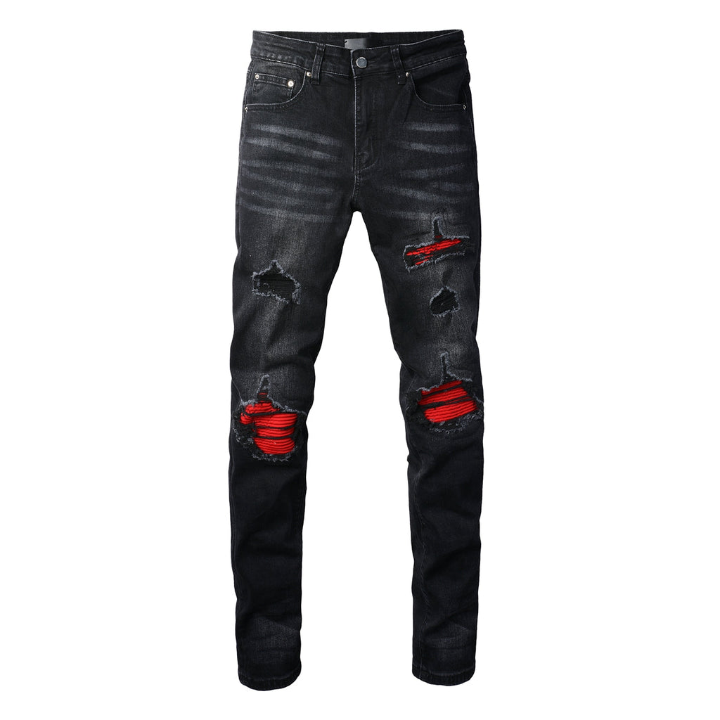 AMIRI black jeans waistband close-up showing leather label and metal button