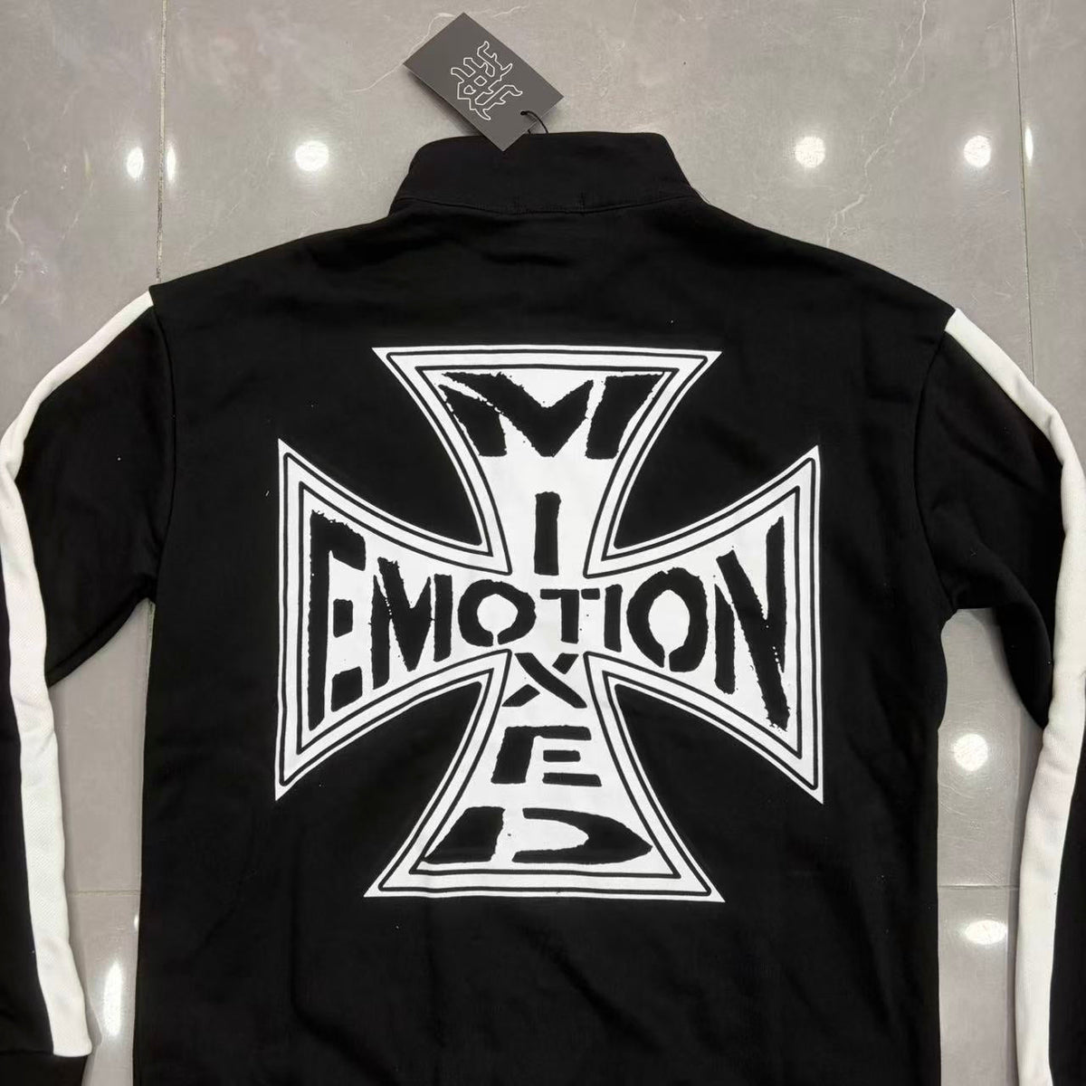 Mixed Emotion tracksuit set laid flat — jacket and pants together