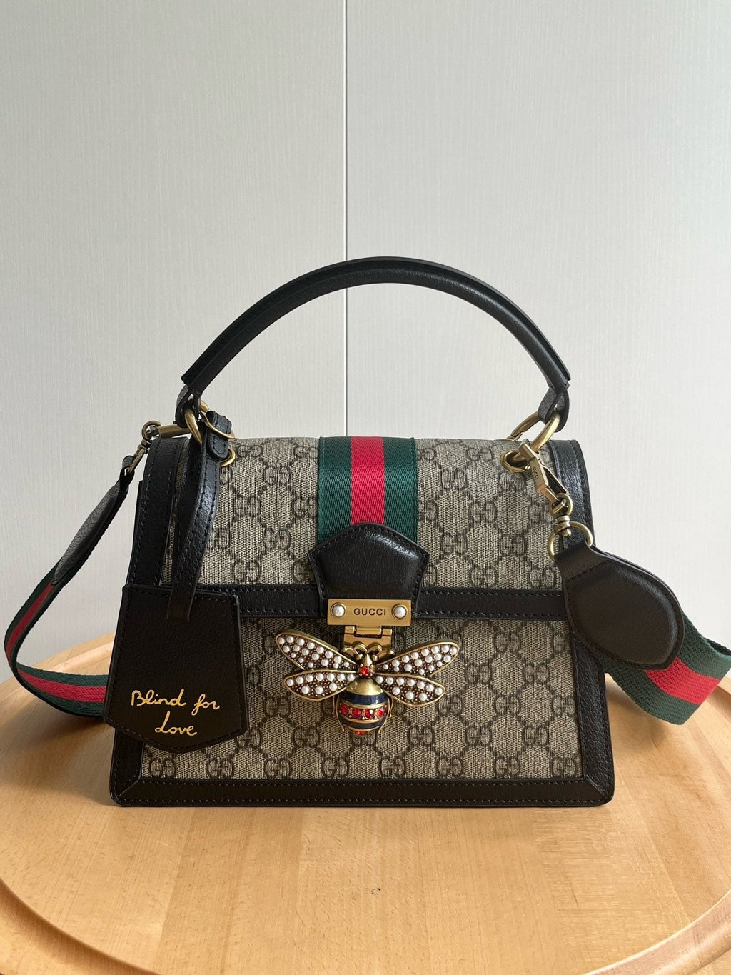 Gucci Queen Margaret bag bottom view showing Blind for Love tag and bee clasp