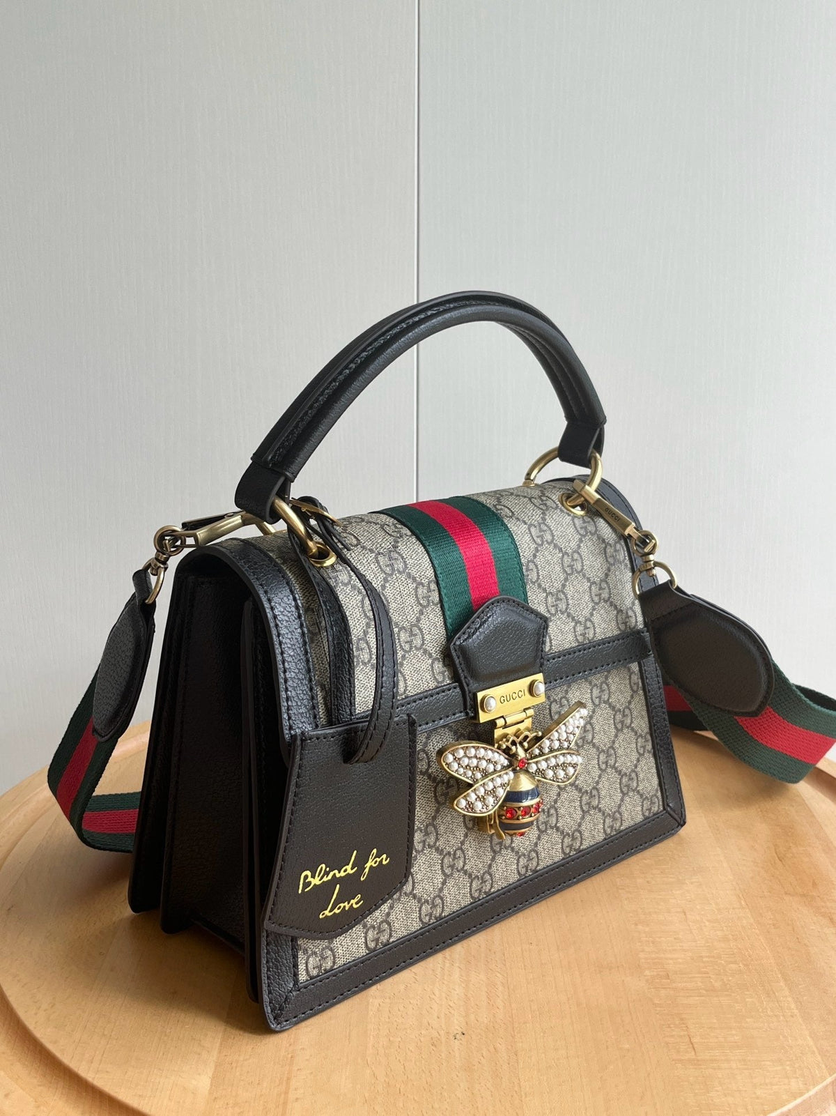 Gucci Queen Margaret bag top handle close-up with gold hardware