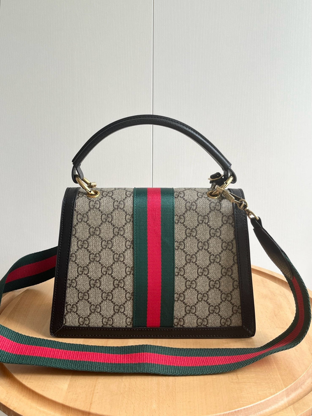 Gucci Queen Margaret GG Supreme bag front view with bee clasp and Web stripe