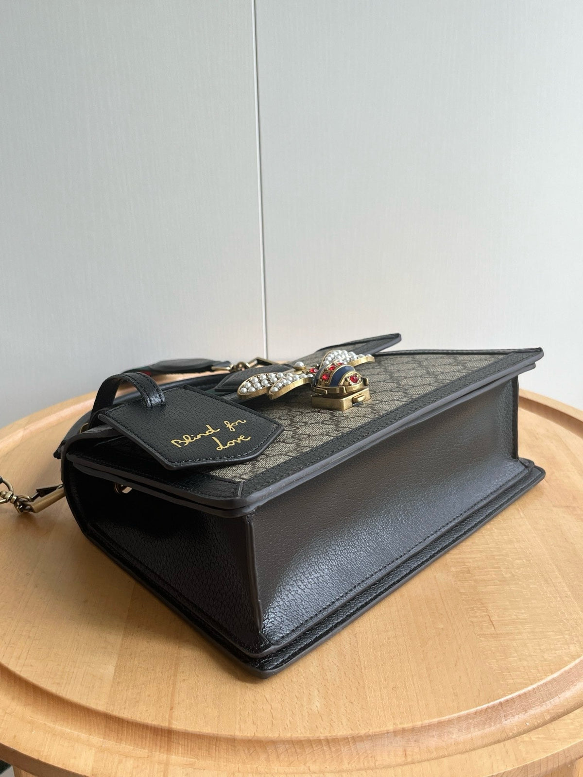 Gucci Queen Margaret bag side angle view on wooden surface