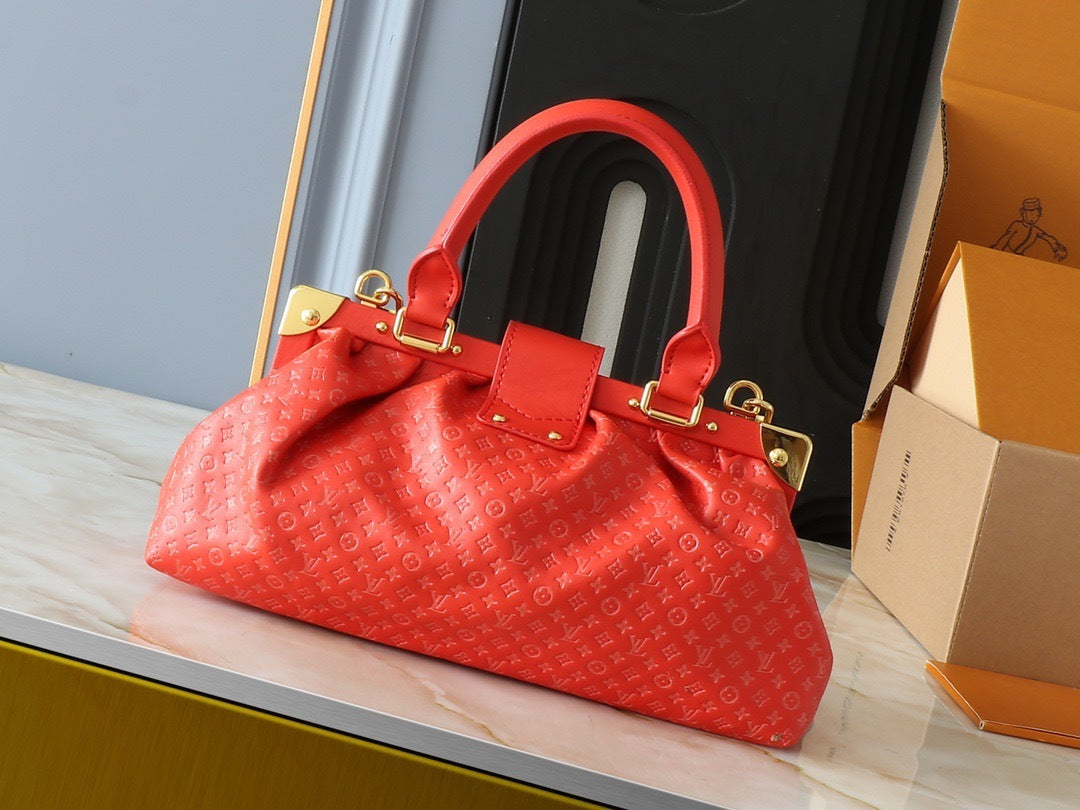 Louis Vuitton gold frame closure detail with LV engraved stud