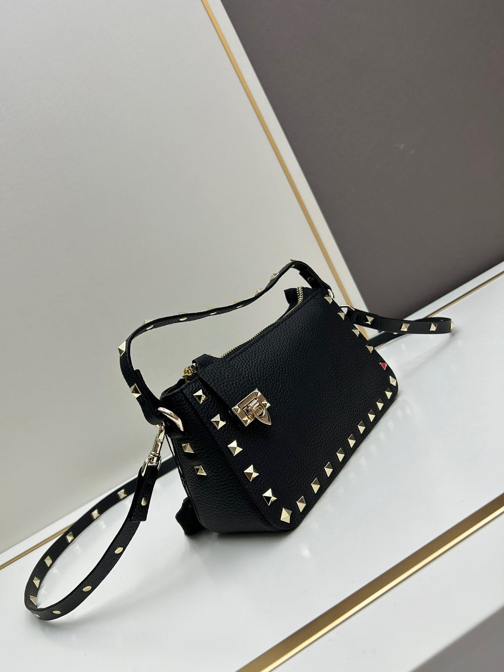 Valentino Garavani Rockstud mini bag in black – front view with crossbody strap