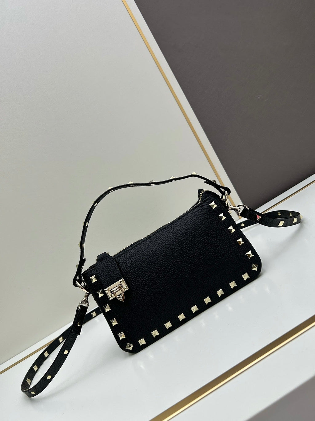 Valentino Garavani Rockstud mini bag – side angle showing push-lock clasp and stud detail