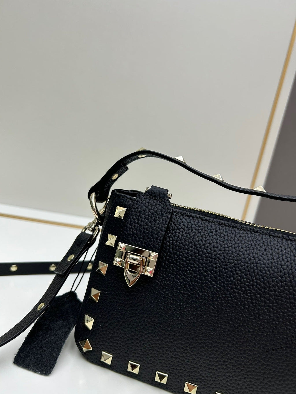 Valentino Garavani Rockstud mini bag – front close-up with gold logo emboss and pyramid studs