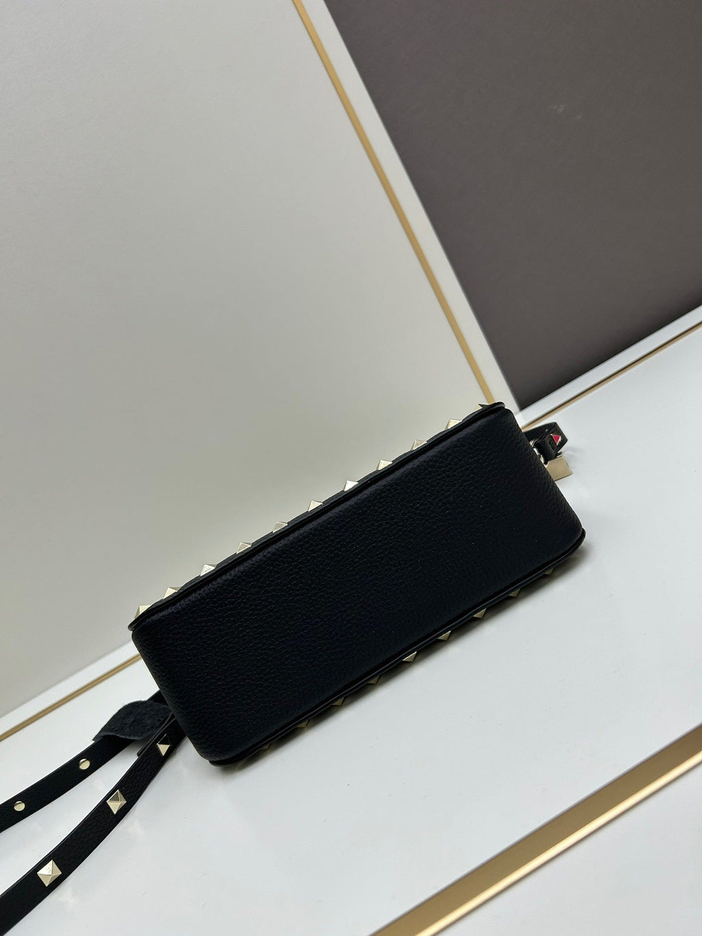 Valentino Garavani Rockstud mini bag – open interior view with gold zip and red label