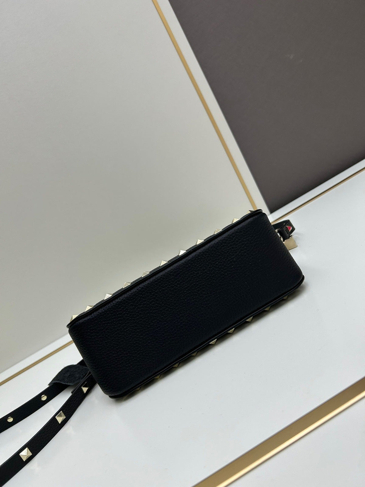 Valentino Garavani Rockstud mini bag – open interior view with gold zip and red label